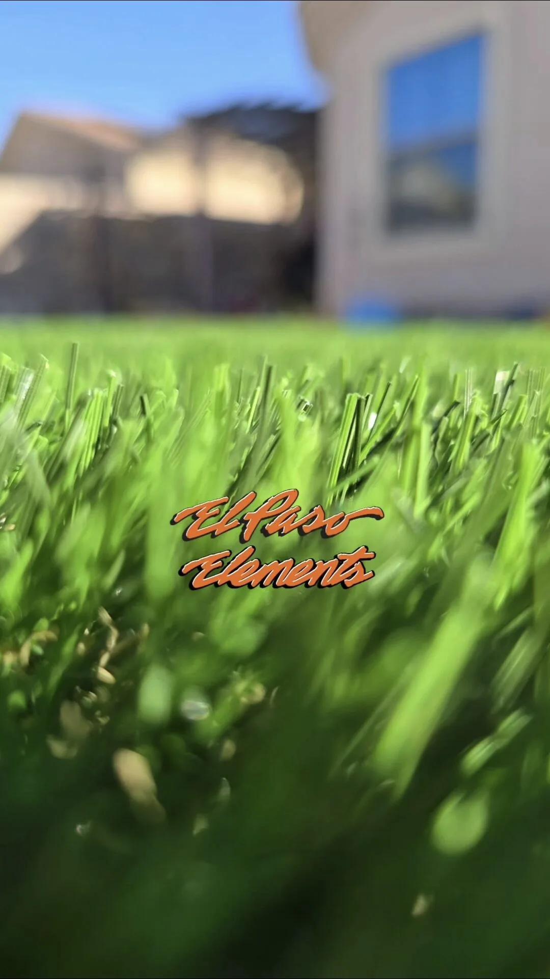 Artificial turf lawn with desert rock landscaping