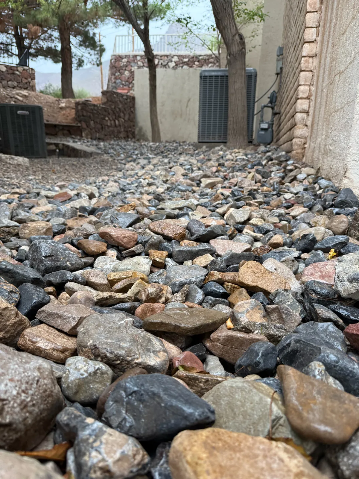 Decorative river rock installation in a completed El Paso landscape